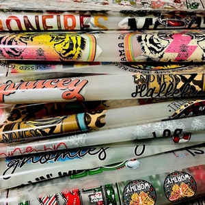 May include: A stack of clear vinyl sheets with various colorful designs printed on them. The designs include text such as "Confident", "Blessed", "Hallelujah", and "Gnomes". There are also images of tigers, butterflies, and other patterns.