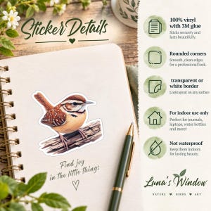 May include: A vinyl sticker featuring a brown and white wren perched on a branch, placed on a spiral notebook. The text reads Sticker Details, Find joy in the little things, and lists features including 3M glue, rounded corners, and indoor use.