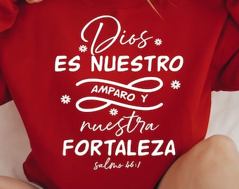 May include: Red sweatshirt with white text that reads "Dios es nuestro amparo y nuestra fortaleza Salmo 46:1".