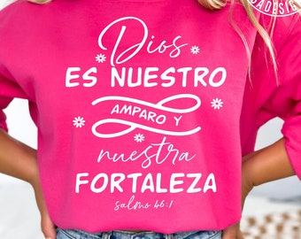 May include: A pink sweatshirt with white text that reads "Dios es nuestro amparo y nuestra fortaleza Salmo 46:1".