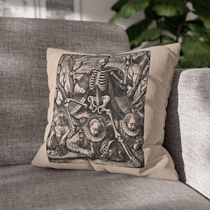 May include: A black and white throw pillow with a vintage illustration of a skeleton holding an hourglass and standing over three people. The illustration is surrounded by a black border.