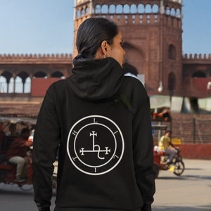 May include: Black hooded sweatshirt with a white sigil on the back. The sigil is a circle with a cross inside and a serpent wrapped around the cross.