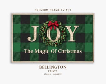 May include: A framed digital art print with a green and black plaid background. The word "JOY" is displayed in large, textured letters, with the "O" replaced by a Christmas wreath and a red bow. The text "The Magic Of Christmas" is below.