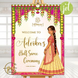 May include: A decorative sign for a Half Saree Ceremony, featuring a cartoon illustration of a woman in traditional Indian attire. The sign is predominantly pink and gold, with floral accents and the text "Welcome to Advika's Half Saree Ceremony."