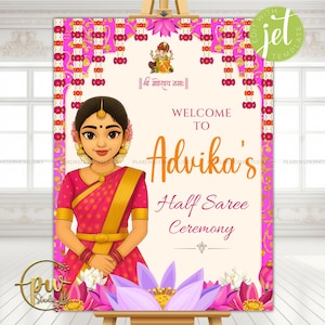 May include: A welcome sign for Advika's Half Saree Ceremony. The sign features a cartoon illustration of a woman in a pink sari, with gold accents. The sign has a pink and gold floral border and includes the text "Welcome to Advika's Half Saree Ceremony."