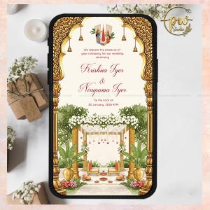 May include: A smartphone displaying a wedding invitation with ornate gold detailing. The invitation features the names "Krishna Iyer & Nirupama Iyer" and the wedding date. The design includes floral and architectural elements, with the text "Tie the knot on 20 January, 2026 4PM."
