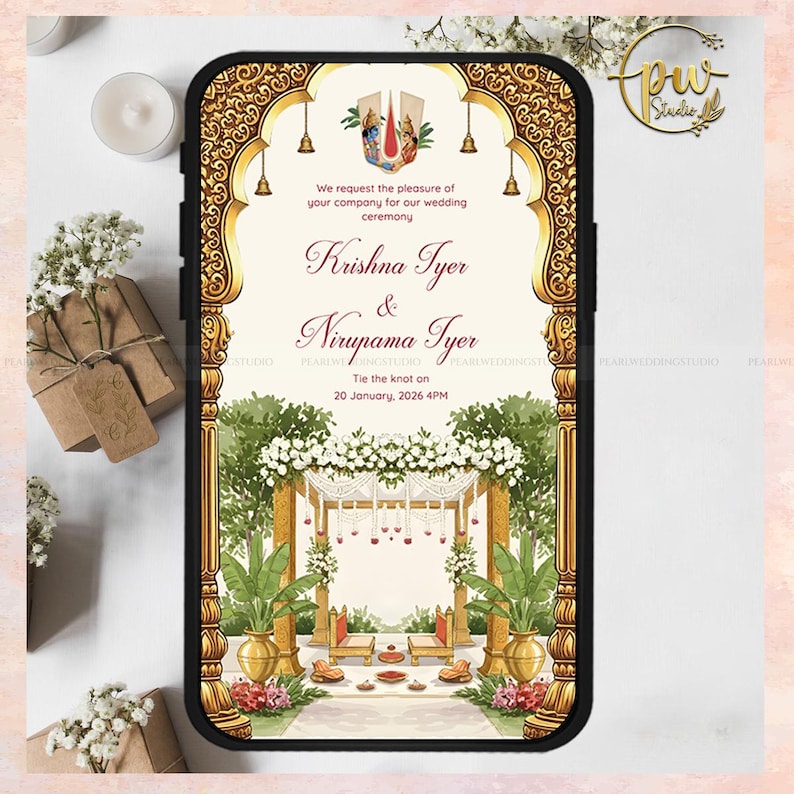 May include: A smartphone displaying a wedding invitation with ornate gold detailing. The invitation features the names "Krishna Iyer & Nirupama Iyer" and the wedding date. The design includes floral and architectural elements, with the text "Tie the knot on 20 January, 2026 4PM."