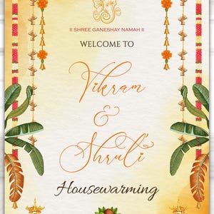 May include: A wedding welcome sign with a warm, yellow and orange gradient background. The sign features the names "Vikram & Shruti" in elegant script, with floral and decorative elements. The text "Welcome To" and "Housewarming" are also visible.