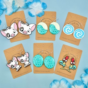 May include: Five pairs of handmade polymer clay earrings inspired by Disney's Moana. The earrings feature characters from the movie, including Pua and Hei Hei, as well as the ocean and the heart of Te Fiti.