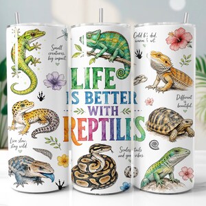 May include: A white cylindrical tumbler featuring colourful illustrations of various reptiles including a gecko, chameleon, bearded dragon, tortoise, and snake. The text reads Life is better with reptiles, Small creatures, big impact, Live slow, stay wild, Cold blooded, warm heart, Different is beautiful, and Scales, tails and good vibes.