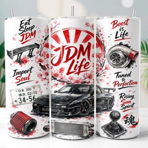 Op de afbeelding: Een witte cilindrische beker met een zwarte sportwagen, een turbolader, een versnellingspook en een achterspoiler. Het ontwerp bevat roze kersenbloesems, een rode zon-afbeelding en de tekst Eat Sleep JDM, JDM Life, Boost is Life en Import Soul.