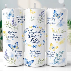 May include: Three white cylindrical tumblers with metal straws, decorated with blue and yellow watercolor butterflies, lavender sprigs, and inspirational text including Thyroid Warrior Life, Resilience is my superpower, and Stronger than the struggle.