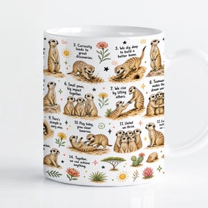 May include: A white ceramic mug featuring a repeating pattern of brown meerkat illustrations. The design includes fourteen numbered points with motivational text, interspersed with small colourful floral, sun, and star icons on a white background.
