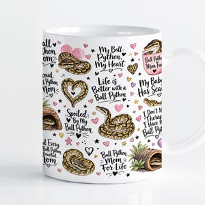 May include: A white ceramic mug featuring a repeating pattern of ball pythons, pink hearts, and text including "My Ball Python, My Heart," "Life is Better with a Ball Python," "Ball Python Mom Fuel," and "Ball Python Mom For Life" in black script.
