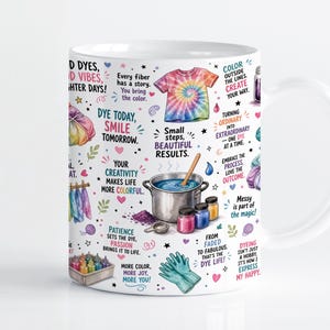 Puede incluir: Una taza de cerámica blanca con un tema colorido de teñido anudado que incluye ilustraciones de una camiseta, una olla con una cuchara de madera, frascos de tinte y guantes. La taza incluye textos como 'Dye today, smile tomorrow' y 'Every fiber has a story'.
