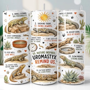 May include: A white cylindrical tumbler featuring illustrations of Uromastyx lizards, desert plants, and rocks. The design includes numbered text captions such as 1. Small lizard, big personality, 10. Nature inspires, Uromastyx remind us, and 13. In their world, we learn peace.