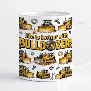 May include: A white ceramic mug featuring a repeating pattern of yellow bulldozers, metal gears, bolts, and orange traffic cones. The centre text reads Life is better with BULLDOZERS in yellow and black lettering with a tyre replacing the letter O.