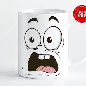 May include: White ceramic mug with a cartoon face printed on it. The face has wide eyes, a wide open mouth, and a tongue sticking out. The mug has a black handle.