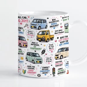 May include: A white ceramic mug featuring a colourful pattern of various small cars in light blue, yellow, pink, and beige. The design includes scattered icons like keys, traffic lights, and hearts, alongside motivational text phrases in multiple colours.