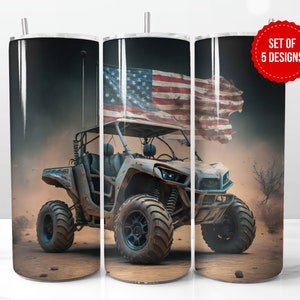 May include: A set of three stainless steel tumblers with a design of an off-road vehicle driving through a desert landscape with an American flag draped over the vehicle. The text "Set of 5 Designs" is visible in the top right corner of the image.
