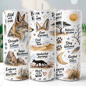 May include: Three cylindrical tumblers with straws featuring a desert-themed design. The print includes a coyote, a black fox silhouette, desert landscapes, a moon, a sun, and text such as Wild and Free, Born to Roam, and Desert Spirit.