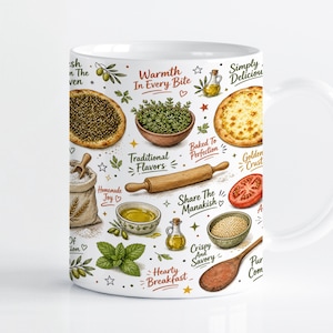 May include: A white ceramic mug featuring a colourful culinary pattern of manakish, olive oil, herbs, a rolling pin, and a wooden spoon. The design includes text such as Warmth In Every Bite, Traditional Flavors, Share The Manakish, and Hearty Breakfast.
