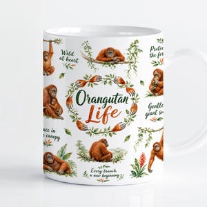Peut inclure: Un mug en céramique blanche orné d'illustrations à l'aquarelle représentant des orangs-outans dans diverses postures parmi un feuillage vert. Le texte "Orangutan Life" est centré dans une couronne de feuilles, entouré de phrases comme "Wild at heart" et "Every branch, a new beginning."