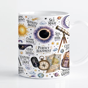 May include: A white ceramic mug featuring a colourful celestial pattern with illustrations of a solar eclipse, telescope, compass, map, and planets. Text includes "Totality Awaits," "Sky Magic," "Seek the Dark," "Perfect Alignment," and "Explore the Skies."