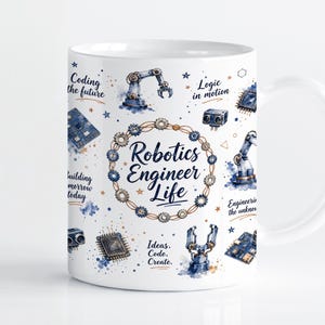 Puede incluir: Una taza de cerámica blanca con un estampado de acuarela en tonos azules y cobre que muestra brazos robóticos, placas de circuitos y engranajes. El texto central dice Robotics Engineer Life, rodeado de frases como Coding the future.