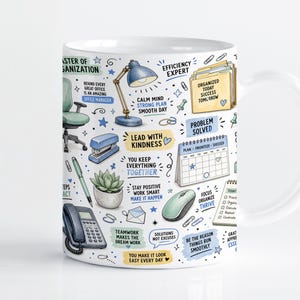 May include: A white ceramic mug featuring a colourful pattern of office supplies and motivational text. Illustrations include a desk lamp, stapler, succulent, telephone, calendar, and file folders with the text Master of Organization.