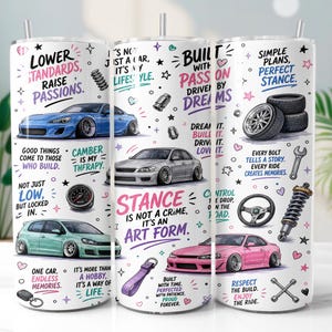 May include: A white cylindrical tumbler featuring a wrap-around graphic print of various lowered cars, automotive parts like tires, steering wheels, and suspension struts, alongside motivational text including "Stance is not a crime, it's an art form."