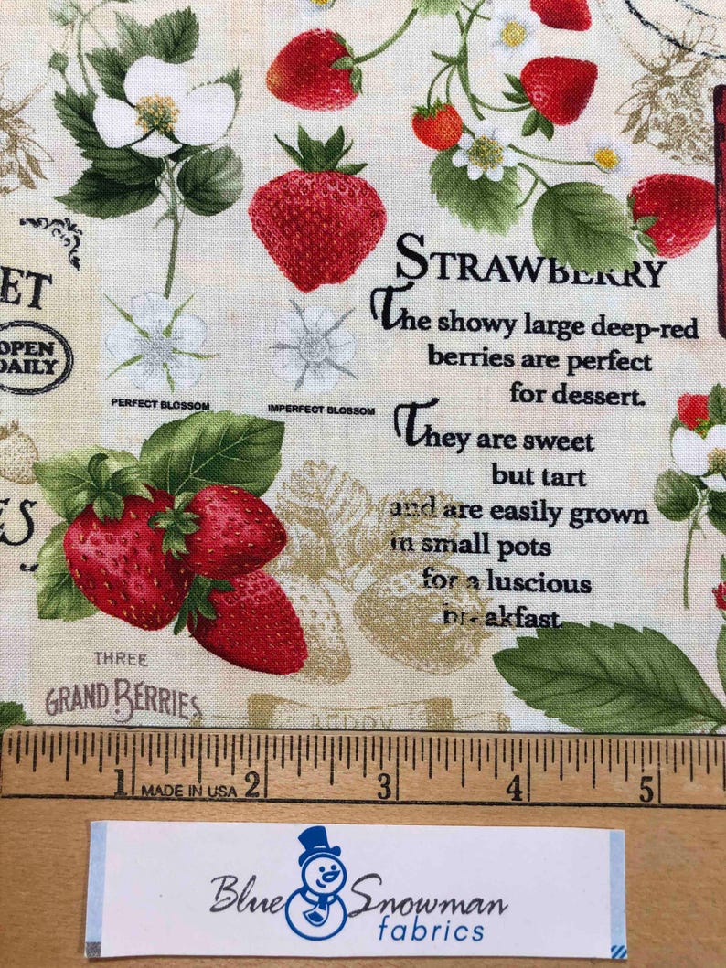 May include: A fabric print featuring strawberries, blossoms, and leaves with the text "STRAWBERRY The showy large deep-red berries are perfect for dessert. They are sweet but tart and are easily grown in small pots for a luscious breakfast THREE GRAND BERRIES".