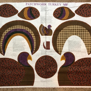 May include: A white fabric panel titled PATCHWORK TURKEY by VIP featuring printed sewing patterns for a turkey. The design includes various shapes with brown, black, purple, and gold plaid and feather patterns, along with printed instructions.