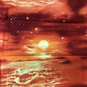 May include: Fabric with a sunset scene. The fabric features a bright orange and red sky with a large sun, clouds, and a body of water. There are also small stars in the sky. The bottom of the fabric has a ruler with inches.