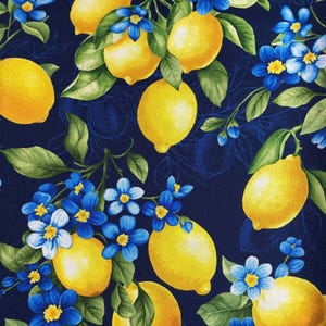 May include: A fabric pattern featuring bright yellow lemons and vibrant blue flowers with green leaves against a dark blue background. The design has a botanical theme, with a repeating pattern of lemons and floral elements.
