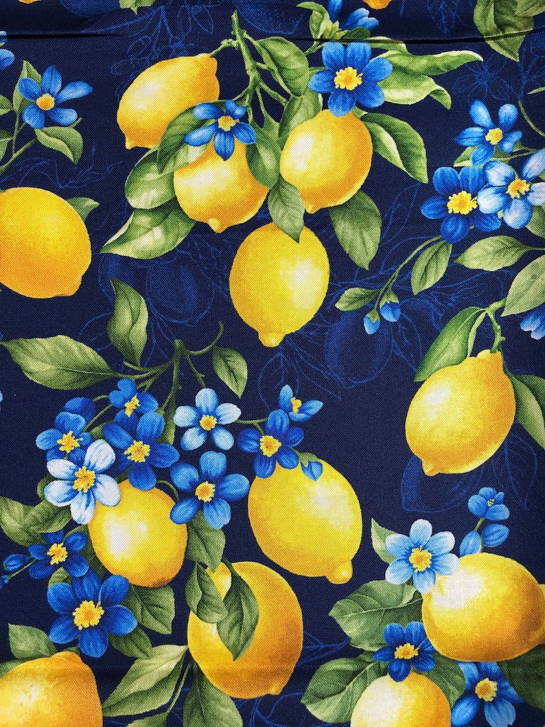May include: A fabric pattern featuring bright yellow lemons and vibrant blue flowers with green leaves against a dark blue background. The design has a botanical theme, with a repeating pattern of lemons and floral elements.