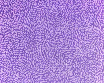 May include: A close-up of a fabric featuring a repeating pattern of stylized floral bursts in shades of purple and lavender. The design has a textured, organic feel, with each burst made of small, leaf-like shapes.