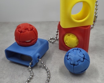 Juguete coleccionable Zorbles con mecanismo de clic, impreso en 3D.