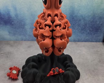 Pulpo magnético impreso en 3D con base de nube de tinta y 3 cangrejos.
