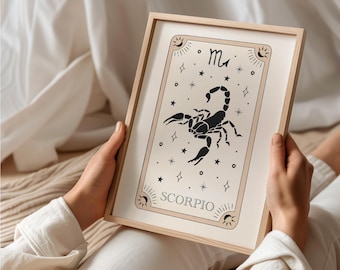 May include: A framed print with a beige background and black scorpion illustration. The print features the zodiac symbol for Scorpio and the word "Scorpio" in black text.