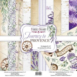 May include: A collection of double-sided decorative paper sheets with a lavender theme. The set includes various designs featuring lavender sprigs, wooden wagon wheels, and the text "Journey to Provence". Each sheet measures 8 x 8 inches.