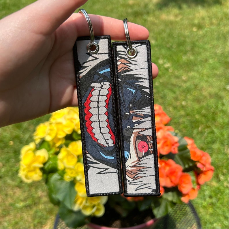 thumbnail interactive-video image 1 of Pokemon Gengar & Mega Gengar Anime Jet Tag Keychain – Double-Sided Fabric Keyring (2023) 1 of 4
