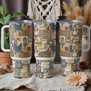 May include: Three insulated tumblers with white handles and lids. The tumblers feature a repeating pattern of vintage farm scenes, including chickens, jars, and the text "HOME SWEET HOME". The bottom of the tumblers have a patchwork quilt design.