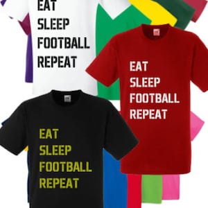 May include: A collection of t-shirts in various colours featuring the text "Eat Sleep Football Repeat" printed on the front. The shirts are available in black, white, red, green, blue, yellow, and pink.