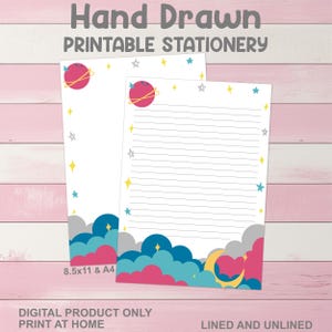 May include: Two sheets of printable stationery with a space theme. The design includes planets, stars, and clouds in shades of pink, blue, and yellow. The text "Hand Drawn Printable Stationery" is at the top. One sheet is lined, the other is unlined.