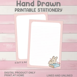 May include: Two sheets of printable stationery with a pink grid border. One sheet is lined, and the other is blank. The lined sheet features a cartoon bunny sitting on a book. Text at the top reads "Hand Drawn PRINTABLE STATIONERY". The dimensions are 8.5x11 & A4.