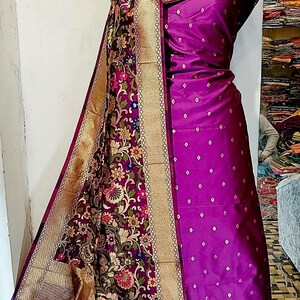 May include: A purple and gold silk dupatta with a floral pattern and a purple silk dress with a white polka dot pattern.