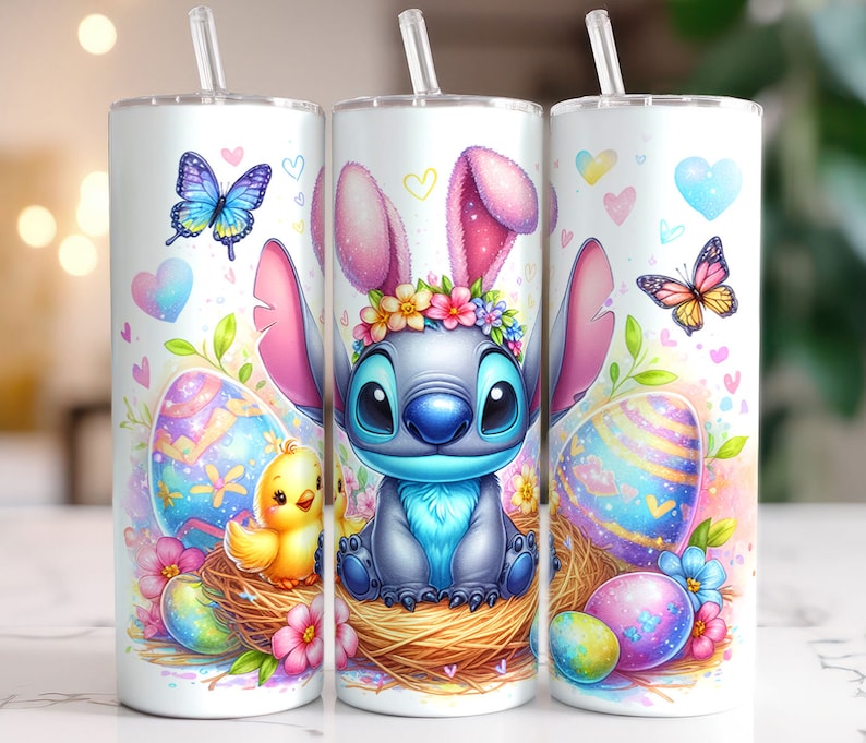 May include: A white tumbler with a colorful Easter design featuring Stitch from Lilo & Stitch dressed as an Easter bunny. The design includes pastel pink, blue, yellow, and green colors with hearts, butterflies, and Easter eggs.