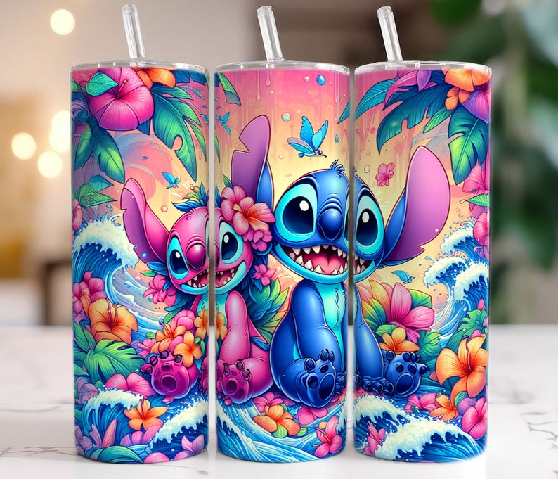 May include: A set of three stainless steel tumblers featuring a vibrant tropical design. The design includes the characters Stitch and Angel, surrounded by colorful flowers, waves, and butterflies. Each tumbler has a clear straw.
