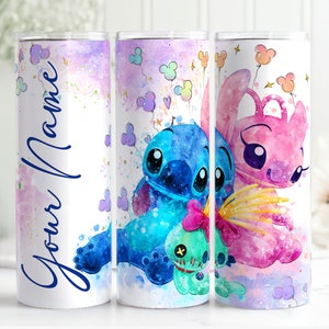 May include: Three stainless steel tumblers with a watercolor design featuring Stitch and Angel from the Disney movie Lilo & Stitch. The tumblers have a white background with pastel pink, blue, and purple watercolor accents. One tumbler has the text "Your Name" in blue cursive writing.